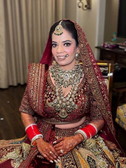 Ashima, looking stunning in her full bridal attire. The makeup is bold enough to match the heavy jewelry and outfit, yet feels natural.