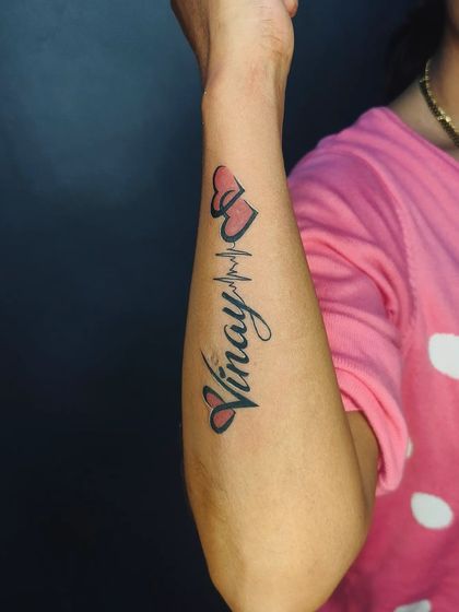 The color version of the "Vinay" heartbeat tattoo. A little bit of red shading in the hearts makes the design stand out on the skin.