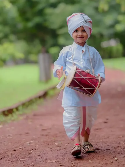 Marching to the beat of his own dhol. This portrait captures the playful spirit of a child dressed in a traditional dhoti and turban for a cultural themed photoshoot. The path in the park provided a perfect natural backdrop.