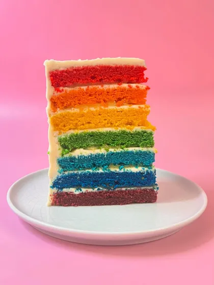 This isn't your average rainbow cake. I call it Oranges & Lemons. It features seven vibrant vanilla sponge layers, whipped white chocolate frosting, and bursts of a bright, fresh citrus curd that cuts through the sweetness. It’s a party in a slice.