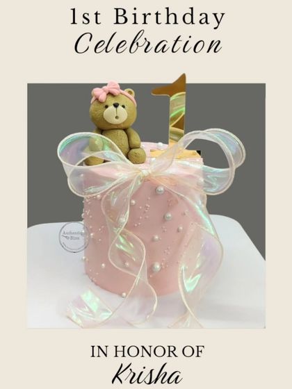 A sweet and simple first birthday cake for little Krisha. This pink cake is topped with a cute teddy bear and wrapped in an iridescent bow.