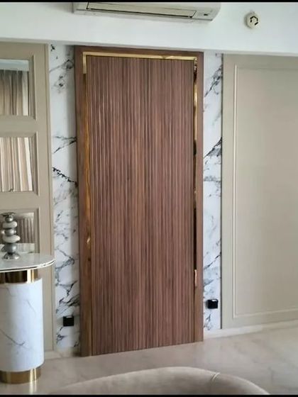 The final result of the camouflaged door next to the console area, blending perfectly into the wall design for a clean, high-end finish.