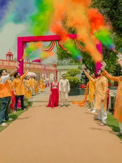 We believe wedding celebrations should be vibrant, energetic, and full of life. This grand entrance at a Haldi ceremony, with friends creating a tunnel of rainbow-colored smoke, perfectly captures the exhilarating joy and festive spirit of Indian weddings.