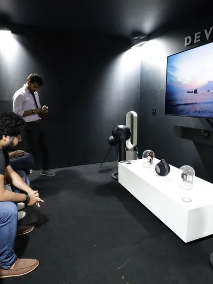 Attendees experiencing a high-end audio demonstration in a dedicated listening room, showcasing the immersive potential of premium AV systems.