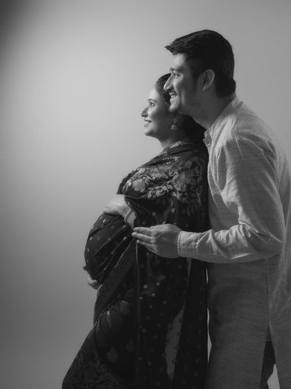 The beauty of togetherness, as they await the greatest adventure of their lives. A black and white portrait capturing hearts full of love and dreams.