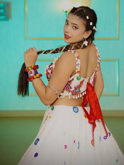 A back view of a white multi-colored chaniya choli, showing the playful design and backless blouse.