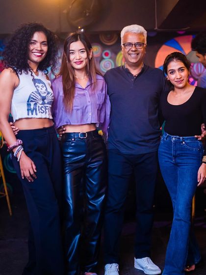 A group of friends, including the iconic Carlton Braganza, enjoying the night.