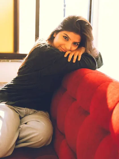 A sweet and simple portrait, leaning over the back of the sofa. This feels very genuine and approachable.