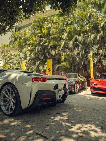 A rear view of the stunning Ferrari supercars lined up. The right music elevates the visual spectacle of a luxury car event, making it an unforgettable experience.
