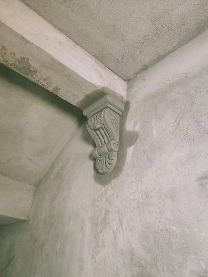 A decorative cement corbel sculpted to support a beam. These small details add a touch of classic architectural beauty and show a commitment to craftsmanship.