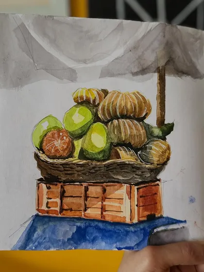 A watercolour still life of a basket of fresh oranges at a local market. I love capturing the vibrant colours and textures of everyday objects.