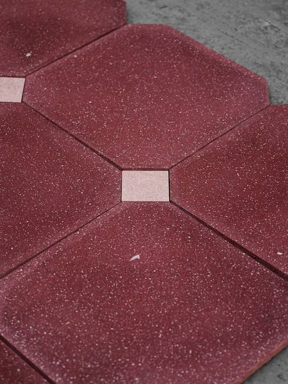 Our red octagon tiles installed with a contrasting white square tile at the intersections, creating a classic, geometric flooring pattern.