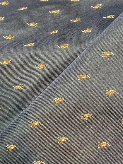 For a more understated look, I offer fabrics like this navy cotton with small, embroidered motifs, perfect for a custom blazer or Nehru jacket.