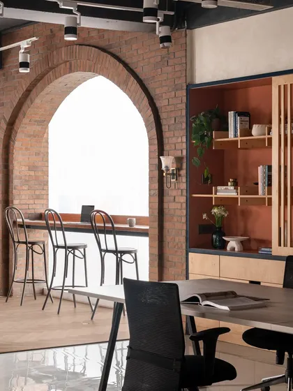 An office should inspire creativity. I designed our own studio with a statement brick arch to frame the large window, creating a bright space for brainstorming or a quiet coffee. It’s a nod to a warm, rustic style that feels both refined and welcoming.