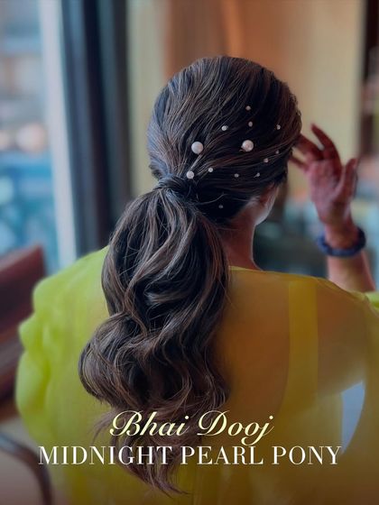 This midnight pearl pony is a chic and modern hairstyle for Bhai Dooj. The sleek ponytail is decorated with scattered pearls, adding a touch of unexpected glamour to the look.