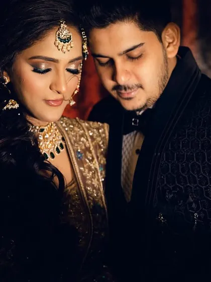 A close-up, intimate portrait of the couple. The focus is on their serene expressions and the beautiful details of the bride's makeup and jewelry.
