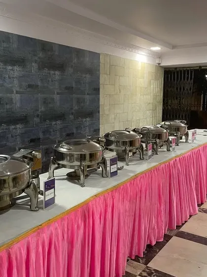 A full buffet line with a pink table skirt, set up for a society gathering in Andheri West. I offer great deals for large events like Diwali parties.