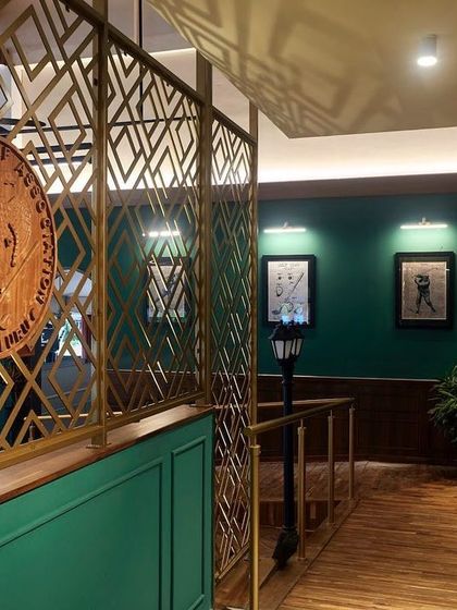 Detail is everything in lighting design. At the KGA bar, I used focused spotlights to catch the texture of the brass decorative screen and highlight the club's emblem, turning architectural elements into key visual features.