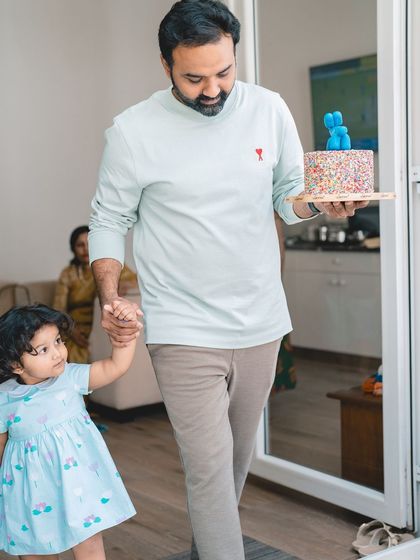 Here comes the cake. Capturing a toddler's birthday party at home allows for authentic, story-telling images of your family's special day.