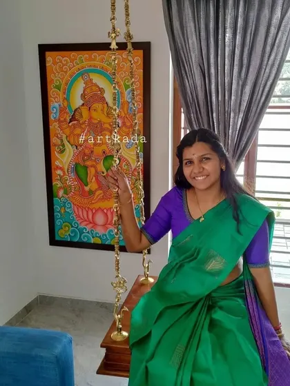 A happy client with her custom Ganesha mural. Paintings of Lord Ganesha are perfect for bringing blessings and removing obstacles, making them a wonderful addition to the entrance of a home.