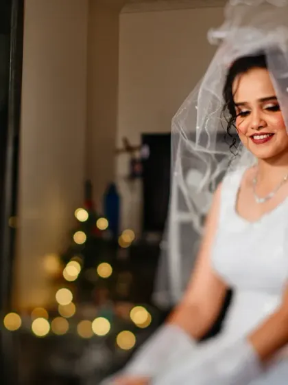 A creative shot using a tilt-shift lens to focus on the bridesmaids in the background as they watch the bride get ready.