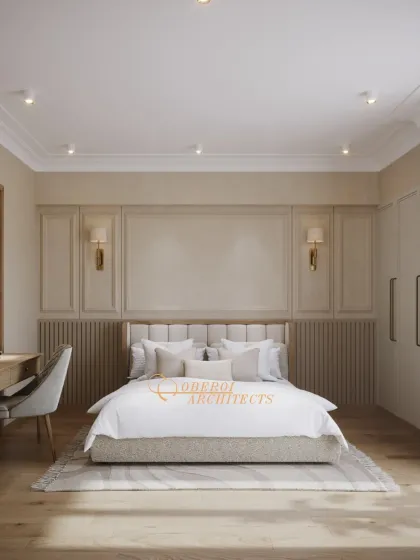 A full view of the bedroom, highlighting the classic wall paneling, symmetrical sconces, and a dedicated workspace, all in a calming neutral palette.