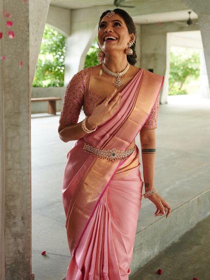 A candid, happy moment with Shwetha Prasad in her lotus pink Kanchivaram ensemble. The custom blouse and saree create a look of pure joy and elegance.