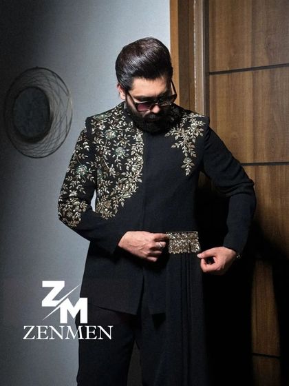 The model adjusting the embroidered belt on the black Indo-Western outfit. This shot highlights the unique details of the design.