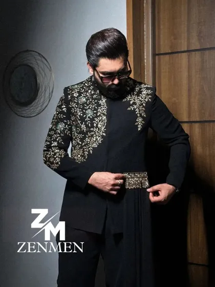 The model adjusting the embroidered belt on the black Indo-Western outfit. This shot highlights the unique details of the design.
