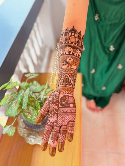 A side view of the arm, highlighting the architectural and elephant motifs that were part of this Canadian bride's custom design.