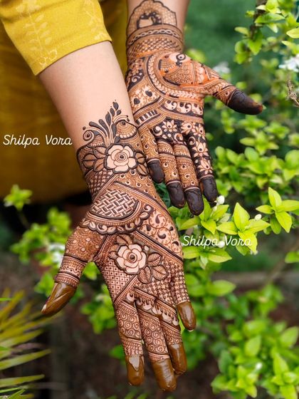 A lovely floral design with roses and intricate net patterns, shown against a natural green backdrop.