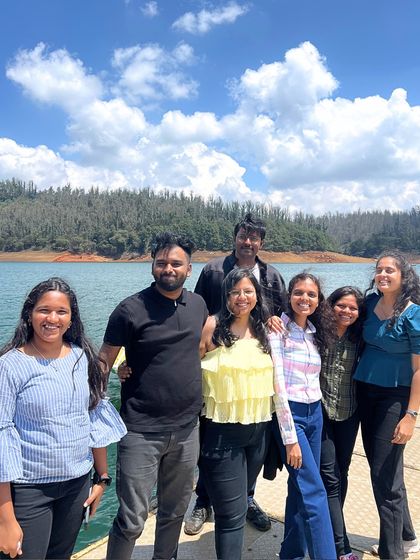 A happy group photo by the beautiful Pykara Lake in Ooty, a perfect spot for boating and relaxing.