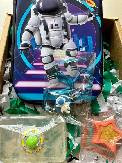 Another version of the astronaut-themed gift box, featuring a hard case pencil box and various space-themed soaps.