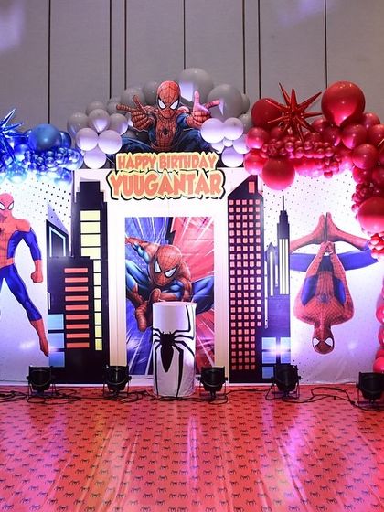 A wide shot of the complete Spider-Man stage. The combination of lighting, balloons, and custom props creates a truly cinematic feel for the birthday celebration.