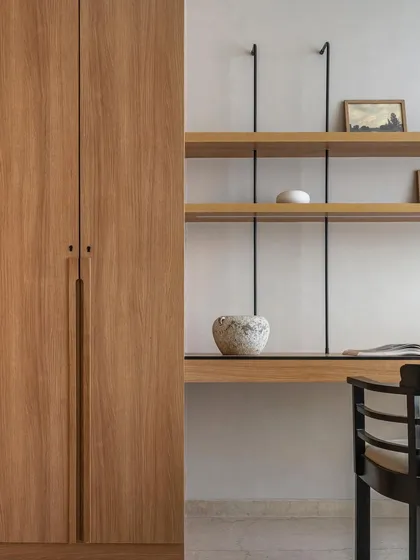 This study in Apartment 3201 features a minimalist floating oak desk and shelving system. The clean lines and natural wood tones create a calm and organized workspace that is both beautiful and highly functional.