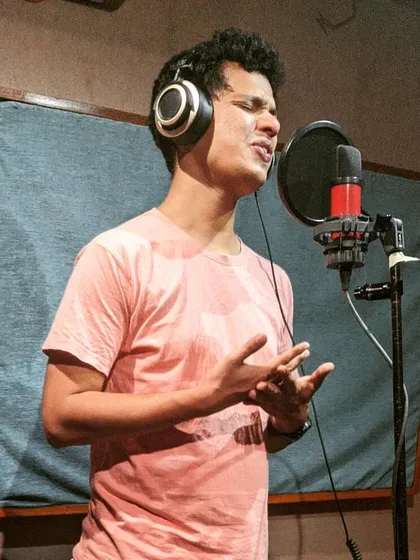 In the studio, recording the vocals for my single. There's a certain kind of magic that happens when you're in the booth, bringing a song you wrote to life.