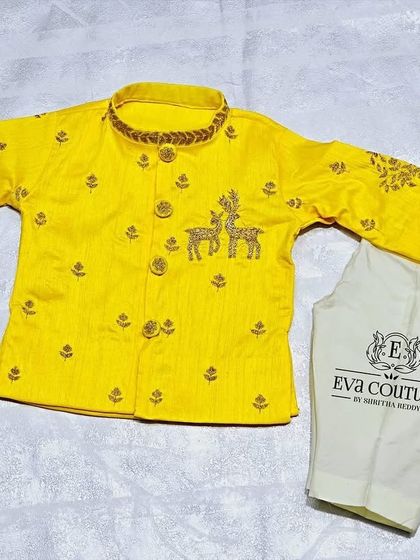A bright yellow kurta set for a newborn. The kurta features delicate deer embroidery on the body and sleeves.