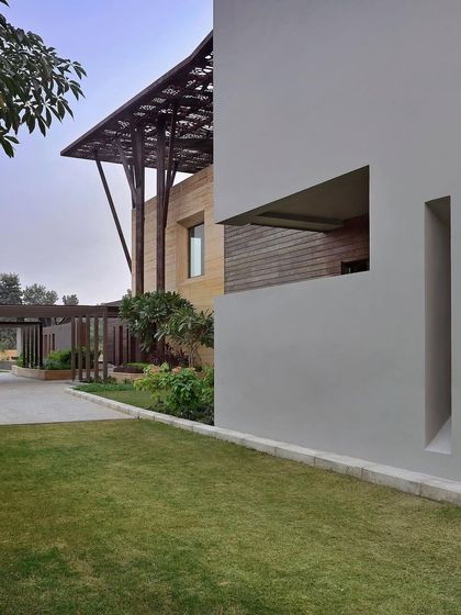 A detail of the Tree House facade, showing the carefully positioned openings in the wall. These are not just windows, but sculptural cuts that create shifting geometries and frame specific views of the surrounding landscape.