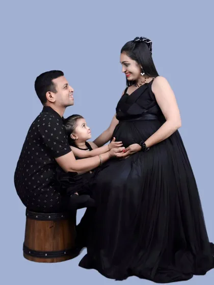 Classic and timeless. This family portrait features our simple black maternity gown paired with a matching black tiered dress for the daughter, creating a chic and coordinated look.