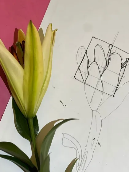 Every great painting starts with an idea. Here, we're brainstorming and sketching concepts for our Georgia O'Keeffe-inspired floral paintings, studying the shapes and lines of a real lily.