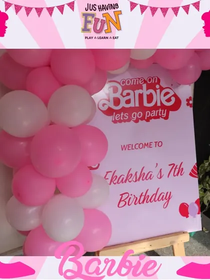 "Come on Barbie, let's go party!" This welcome sign, framed by a pink and white balloon arch, sets the tone for a fabulous Barbie-themed birthday celebration from the moment guests arrive.