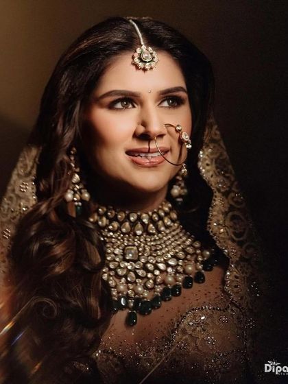 A close-up of the beautiful bride, showcasing her soft, wavy hairstyle.