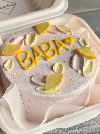 A personal bento cake for "Baba" decorated with cute, hand-piped lemon slices. Custom messages and designs make these little cakes extra special.