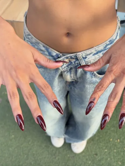 Sometimes you just need bold, statement nails. This long, stiletto shape paired with a deep maroon color gives you that confident, don't-mess-with-me energy. I use strong acrylic extensions to make sure a dramatic look like this is also durable for daily life.