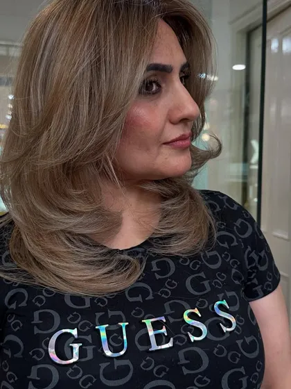 A side view of this flawless blonde transformation. The color is a beautiful, cool-toned beige blonde.