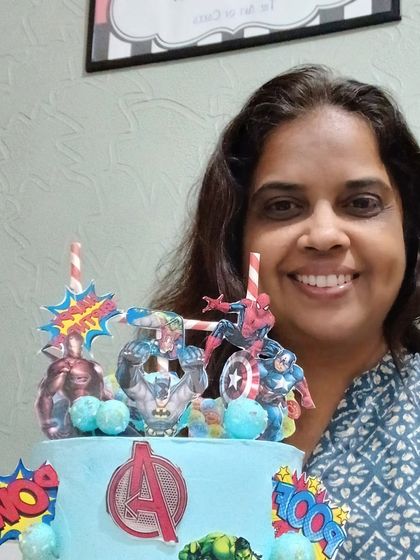 Me, proudly presenting the finished Avengers theme cake.