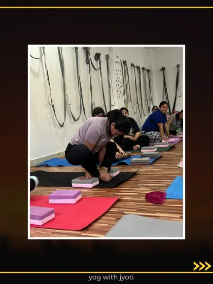 A class works on the preparations for Bhujapidasana, building strength and flexibility.