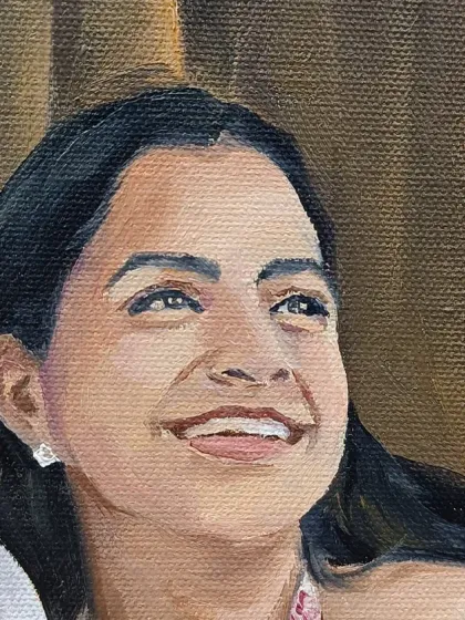 Close-up of the bride's happy, sunlit face.