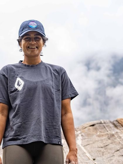 A portrait of a happy climber, chalk on her hands and a smile on her face, after a great day of climbing outdoors.