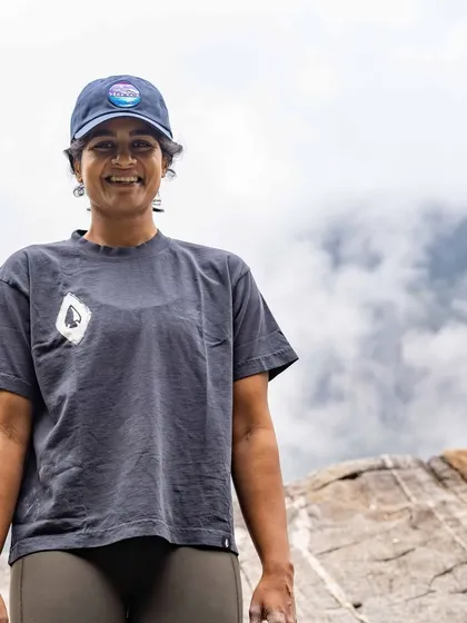 A portrait of a happy climber, chalk on her hands and a smile on her face, after a great day of climbing outdoors.